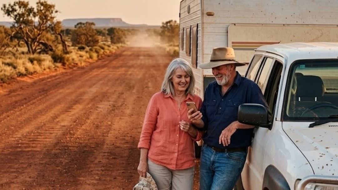 Travellers checking their phone on a remote outback road
